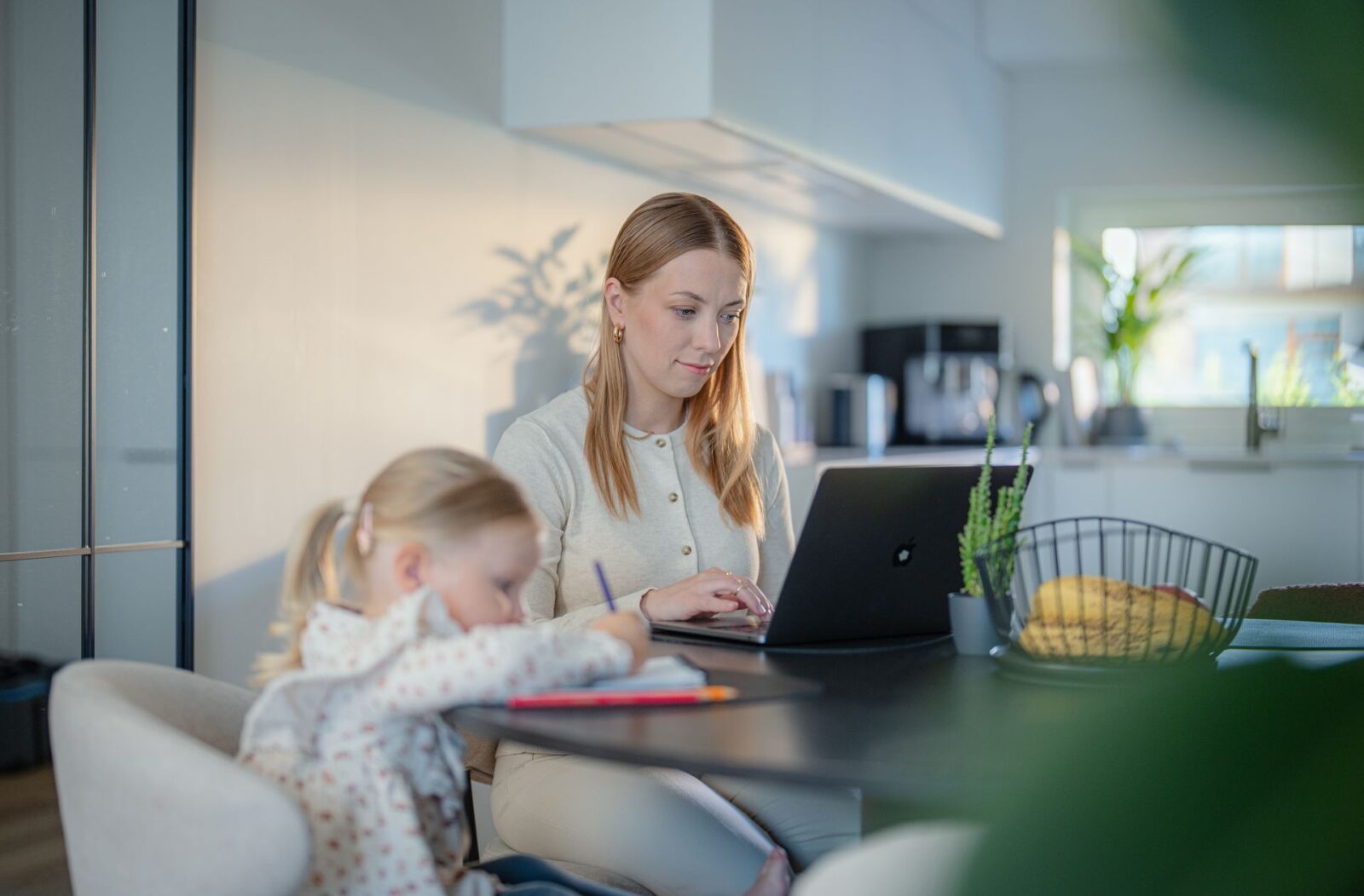 655535-mother-working-from-home-with-child-studying-web-version-1920px